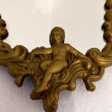 Gilded bronze mirror with angels and scrolls