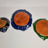 Suite of decorative plates empty enamelled terracotta pockets signed "Gerlou", unique pieces