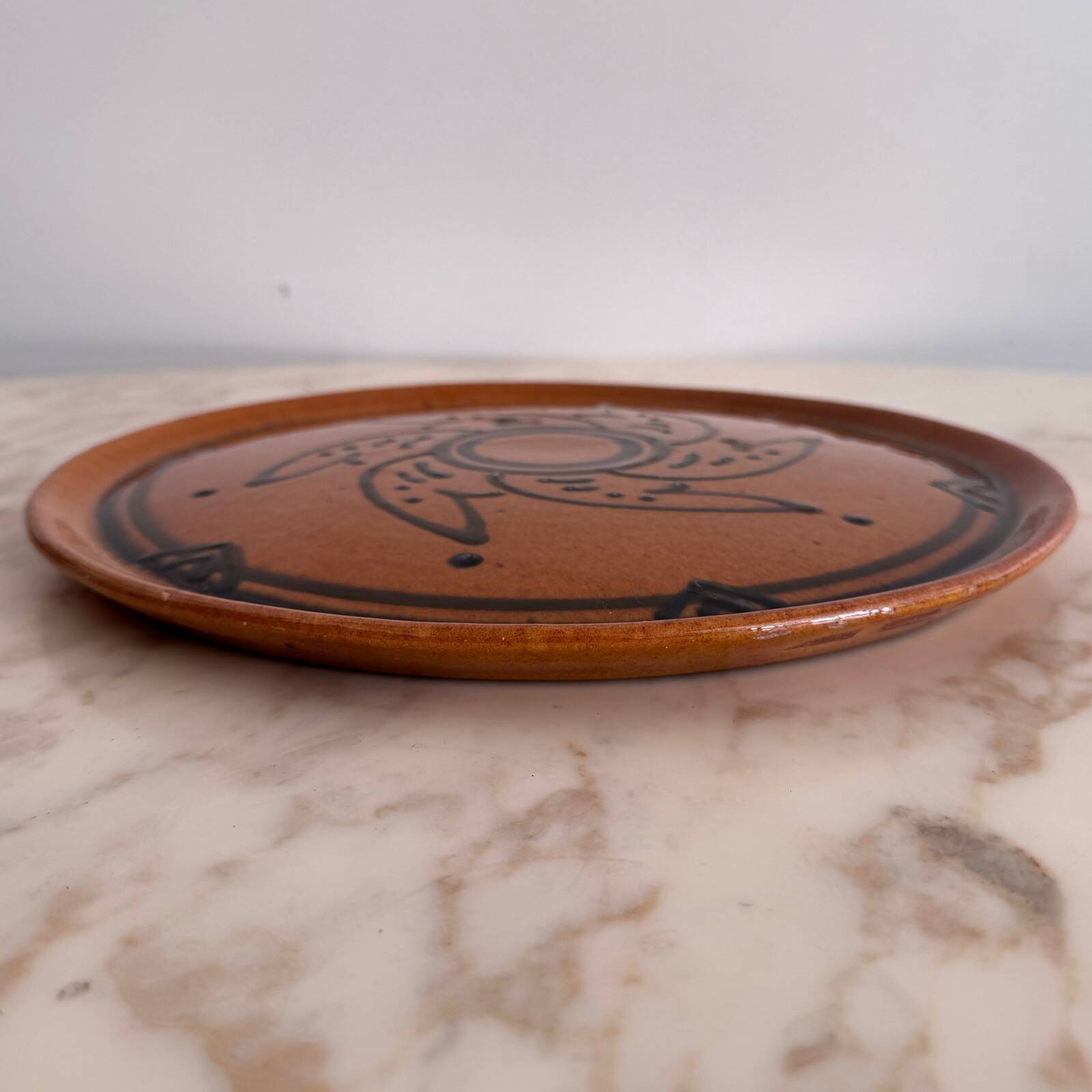 Round glazed earthenware dish by Biot, 20th century, stylized decoration