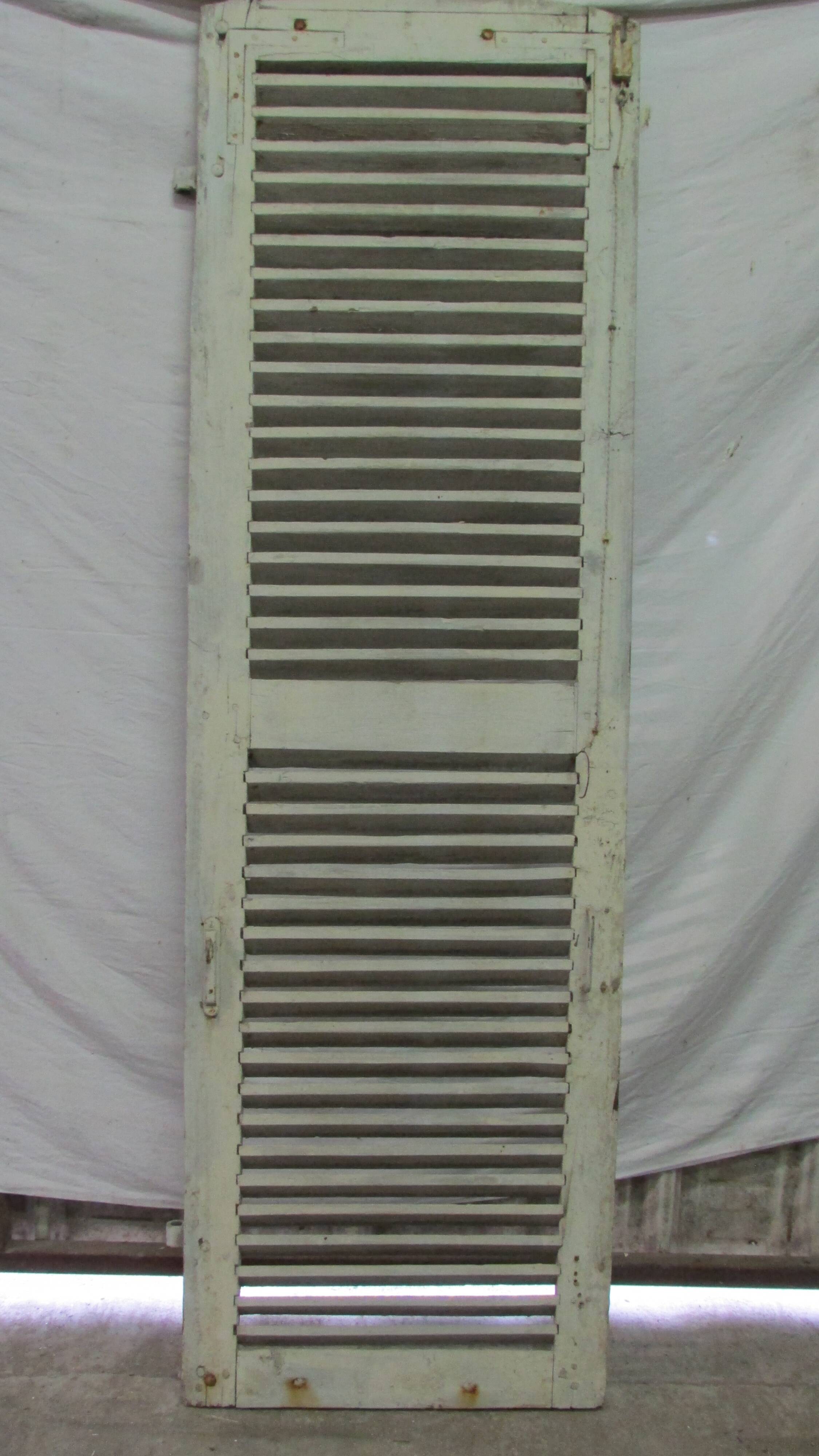 Old wooden shutter with perforations.
