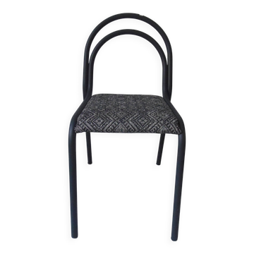 Industrial chair with a tubular metal frame in slate grey.