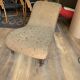 Antique brown recamier armchair in fabric and wood, S-shaped silhouette and turned legs.