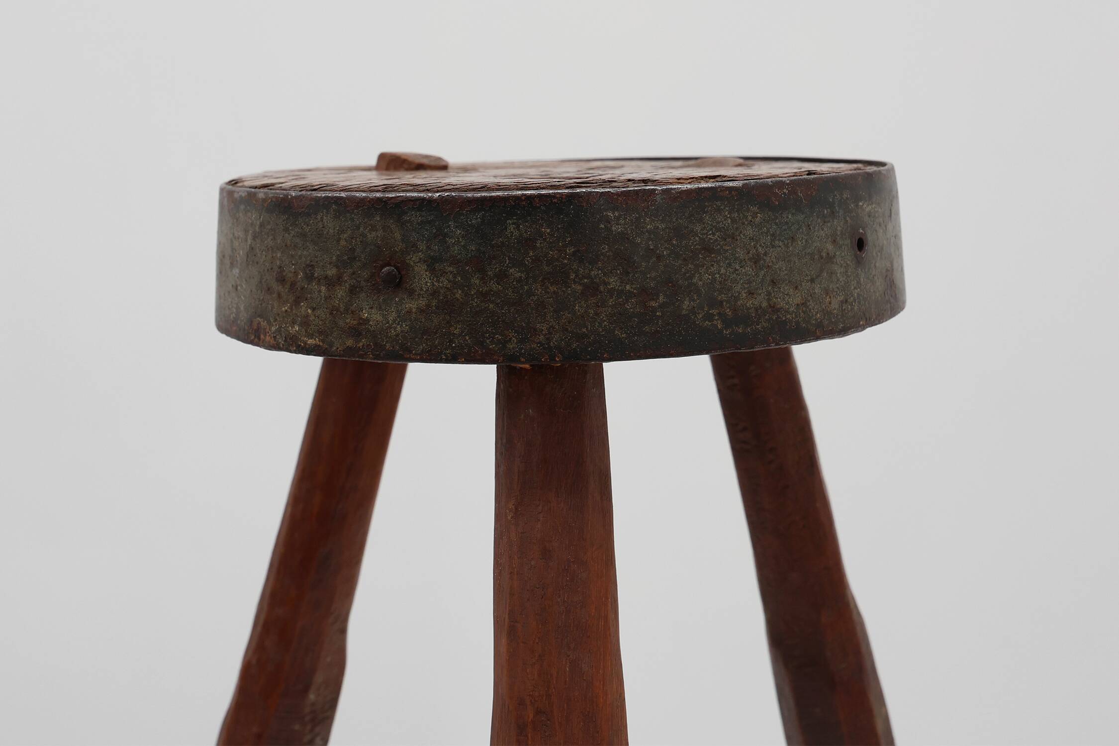 Brutalist French solid oak tripod stool with metal rim, 1850s