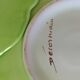 4 hand-decorated earthenware plates with vegetable and green leaf designs.