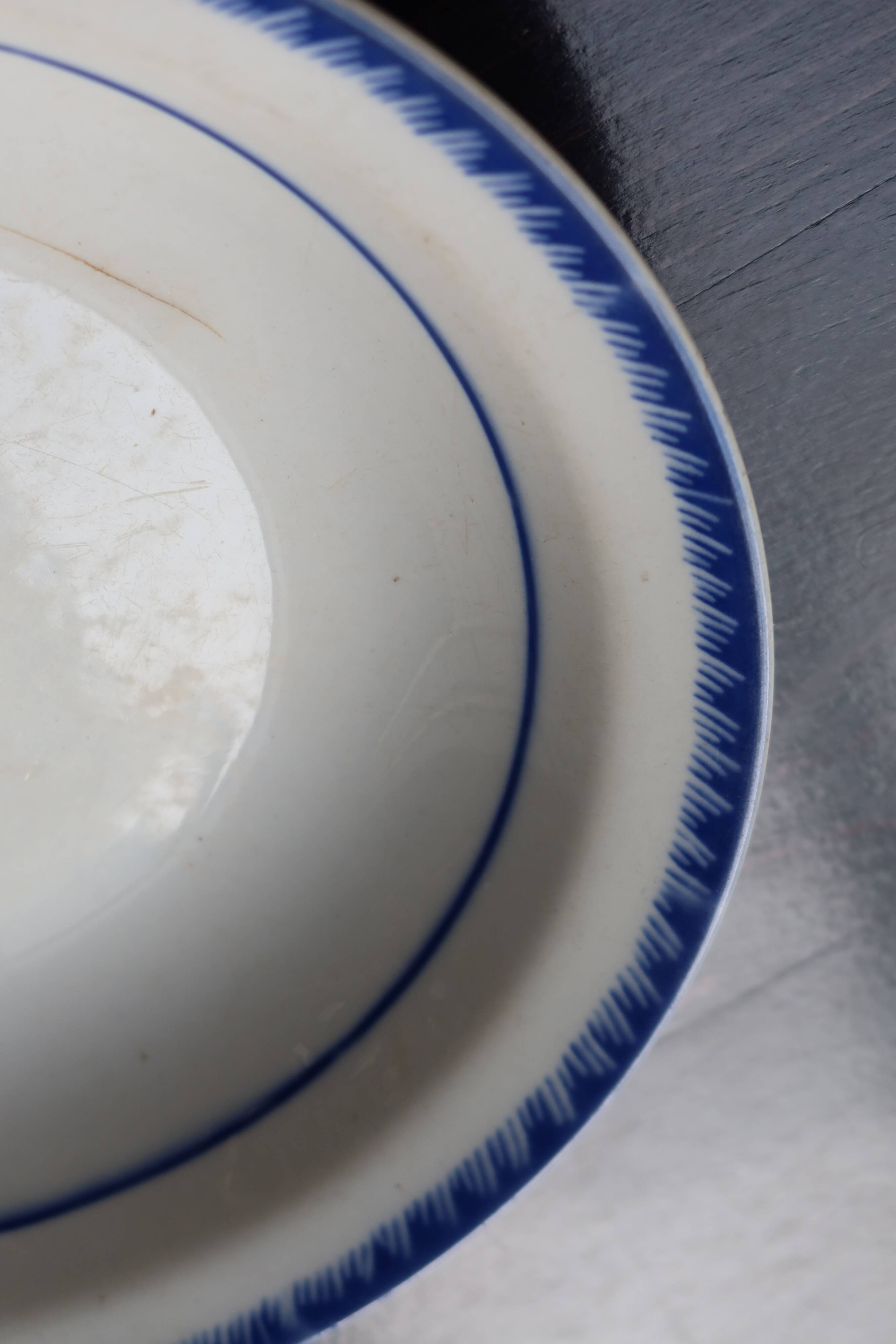 Antique shallow dish from Badonviller with blue flower decoration.