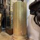 Large fluted golden wood column with a marble top, work from around 1900.