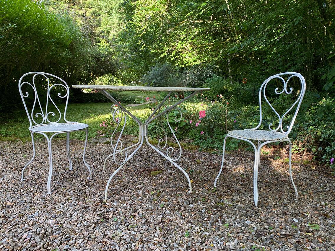 Part of a white lacquered wrought iron garden furniture set