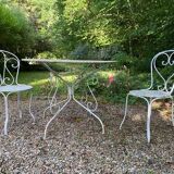 Part of a white lacquered wrought iron garden furniture set