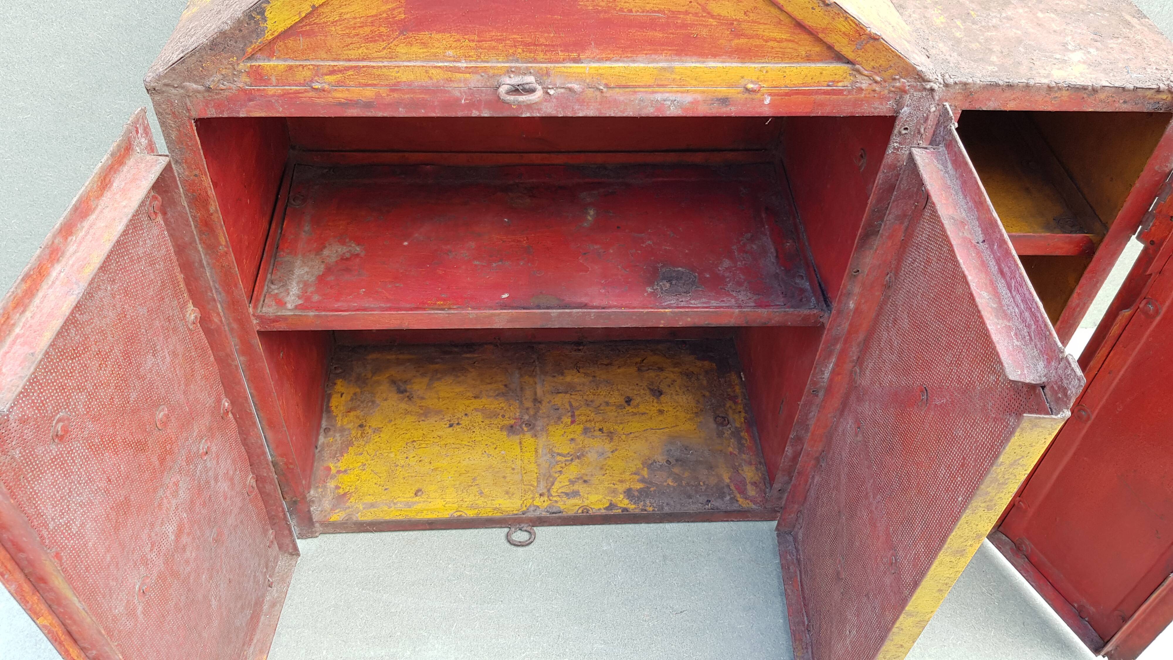 Old atypical metal workshop furniture with its original red patina