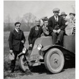 Photograph of a Renault 6CV with 23 admirers including a priest