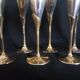 Lot of 12 silver metal flutes on brass stand