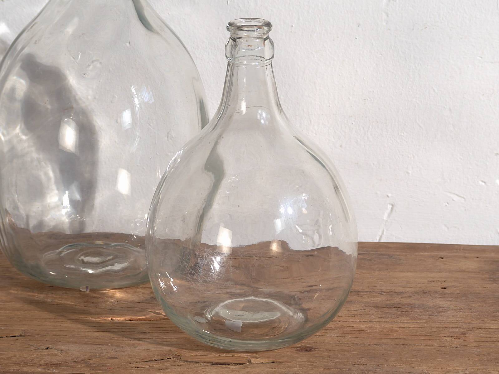 Antique glass demijohns (c.1920). Set of 2 pieces