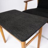 Easy chair with stool in teak and dark wool fabric of danish design from the 1960s.