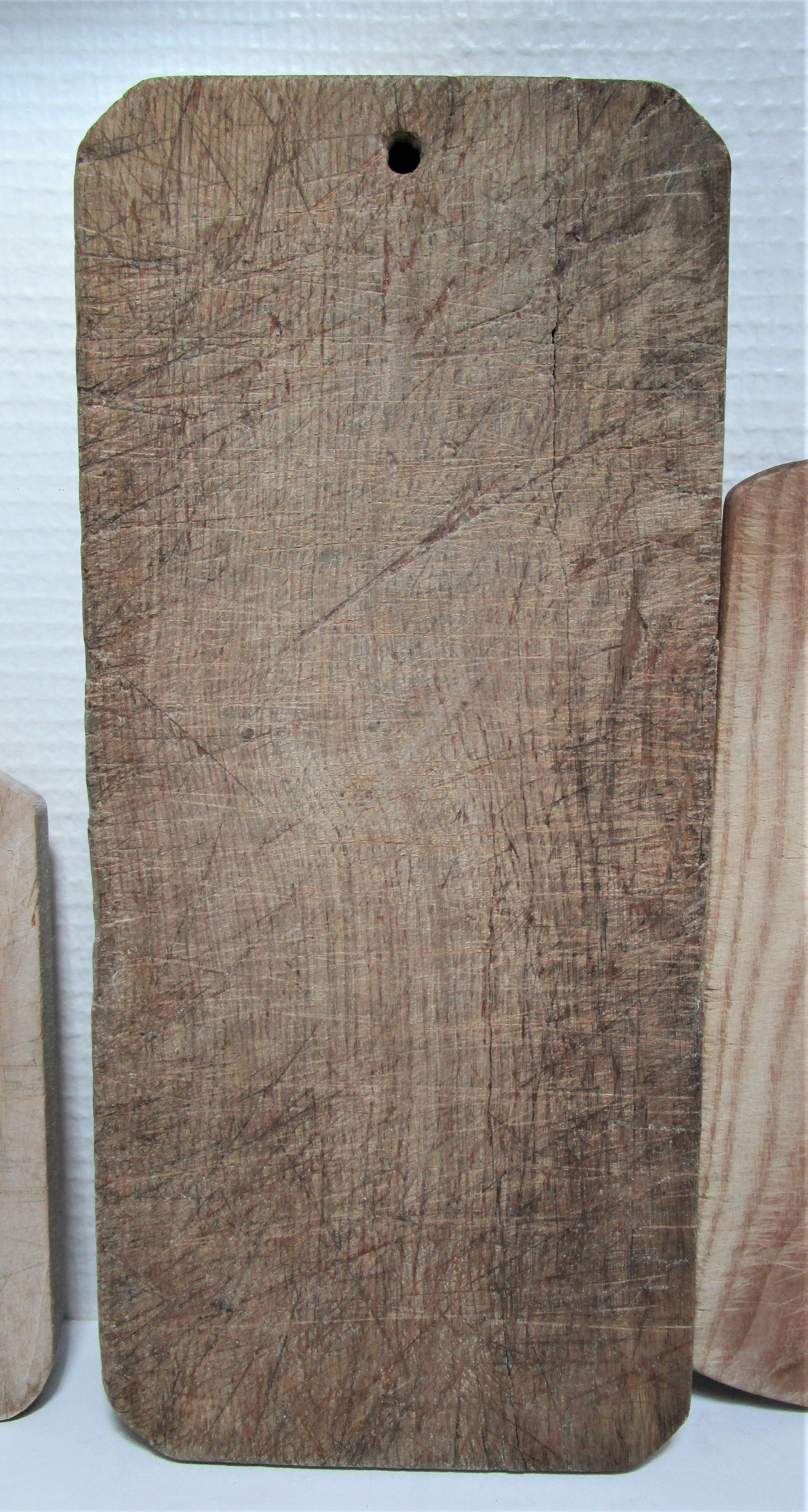 three vintage patinated solid wood cutting boards