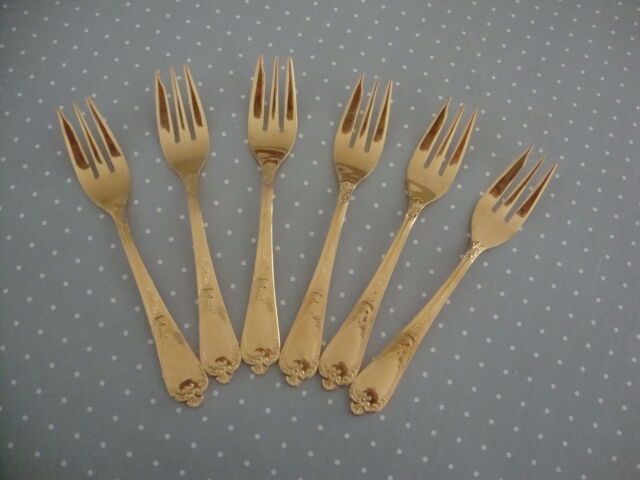 Golden metal cake forks