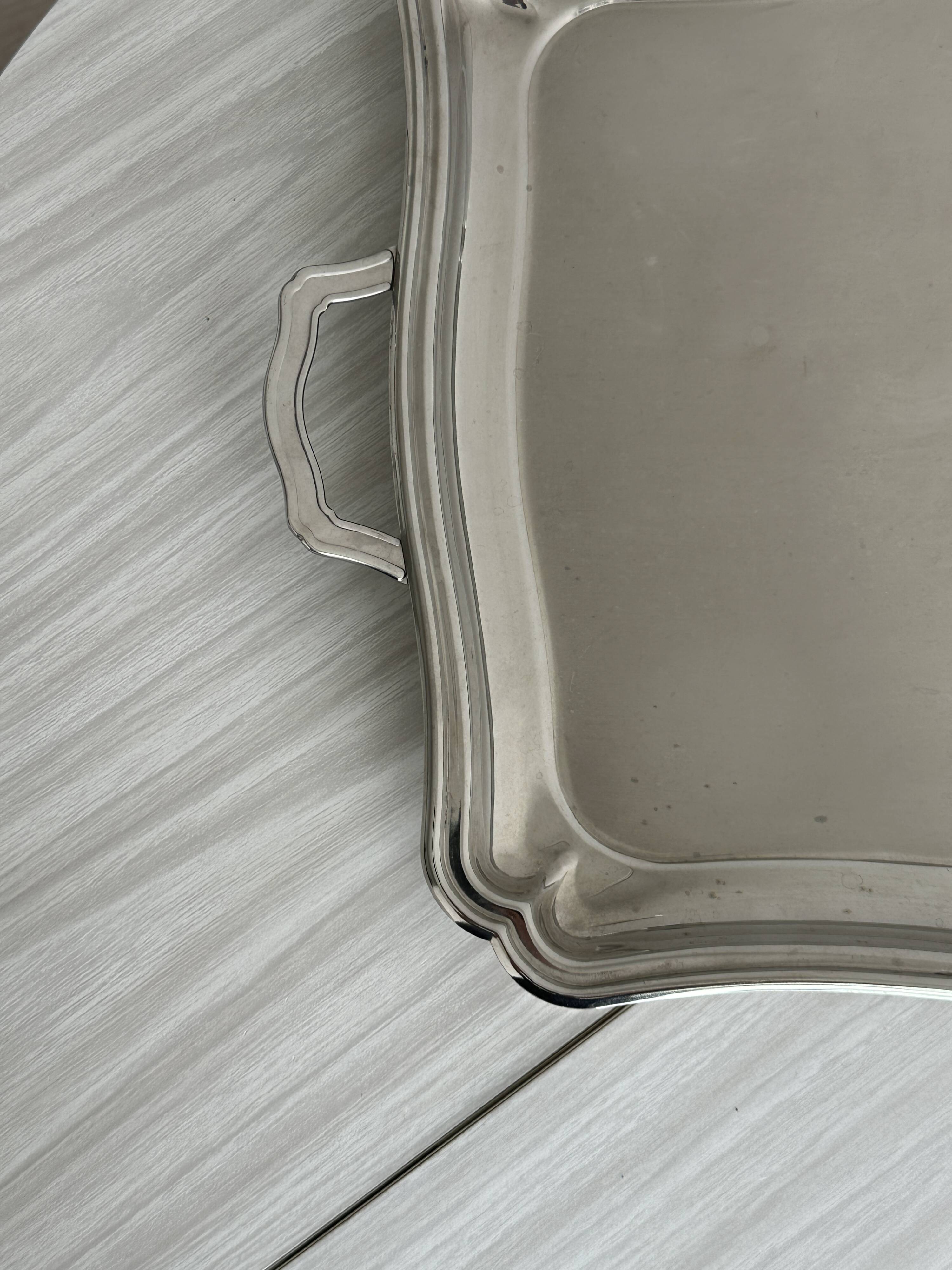 Large shiny metal serving tray