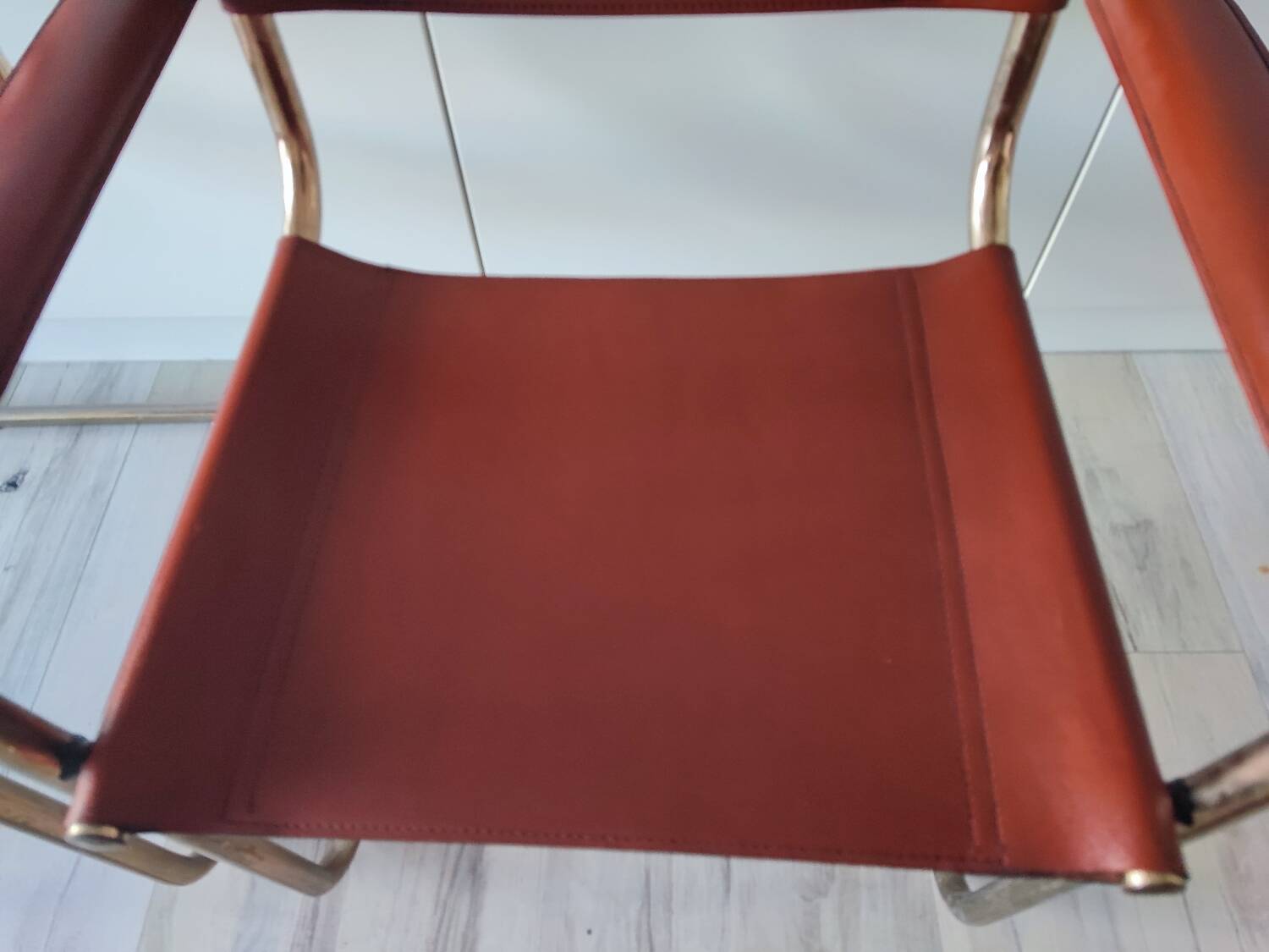 B34 armchairs, cognac leather and gilding