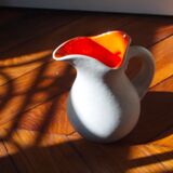 White and orange pitcher with organic curves