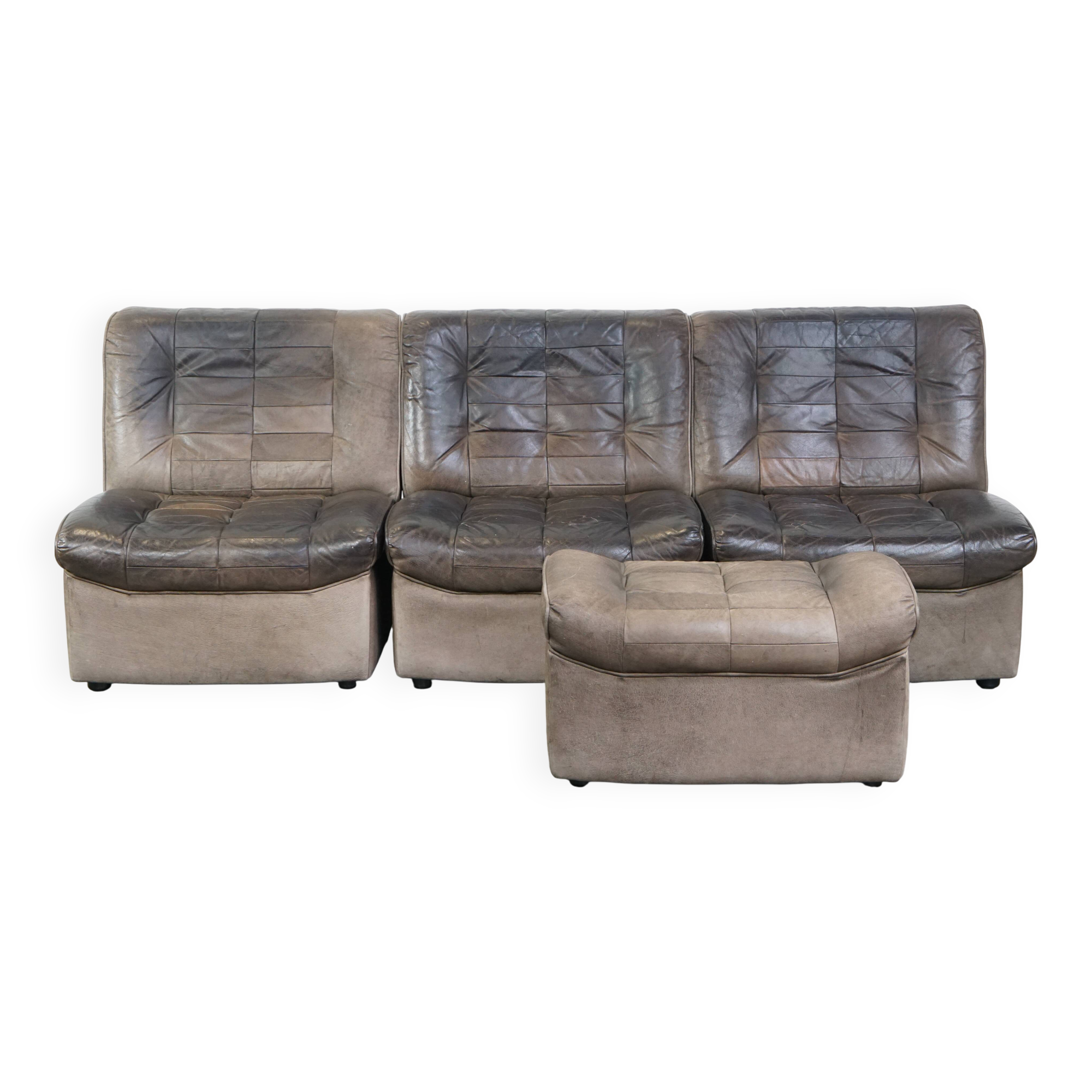 Canapé design modulable en cuir gris, 3 modules et 1 repose-pieds