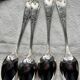 Set of 12 small silver-plated metal spoons in Art Nouveau style.