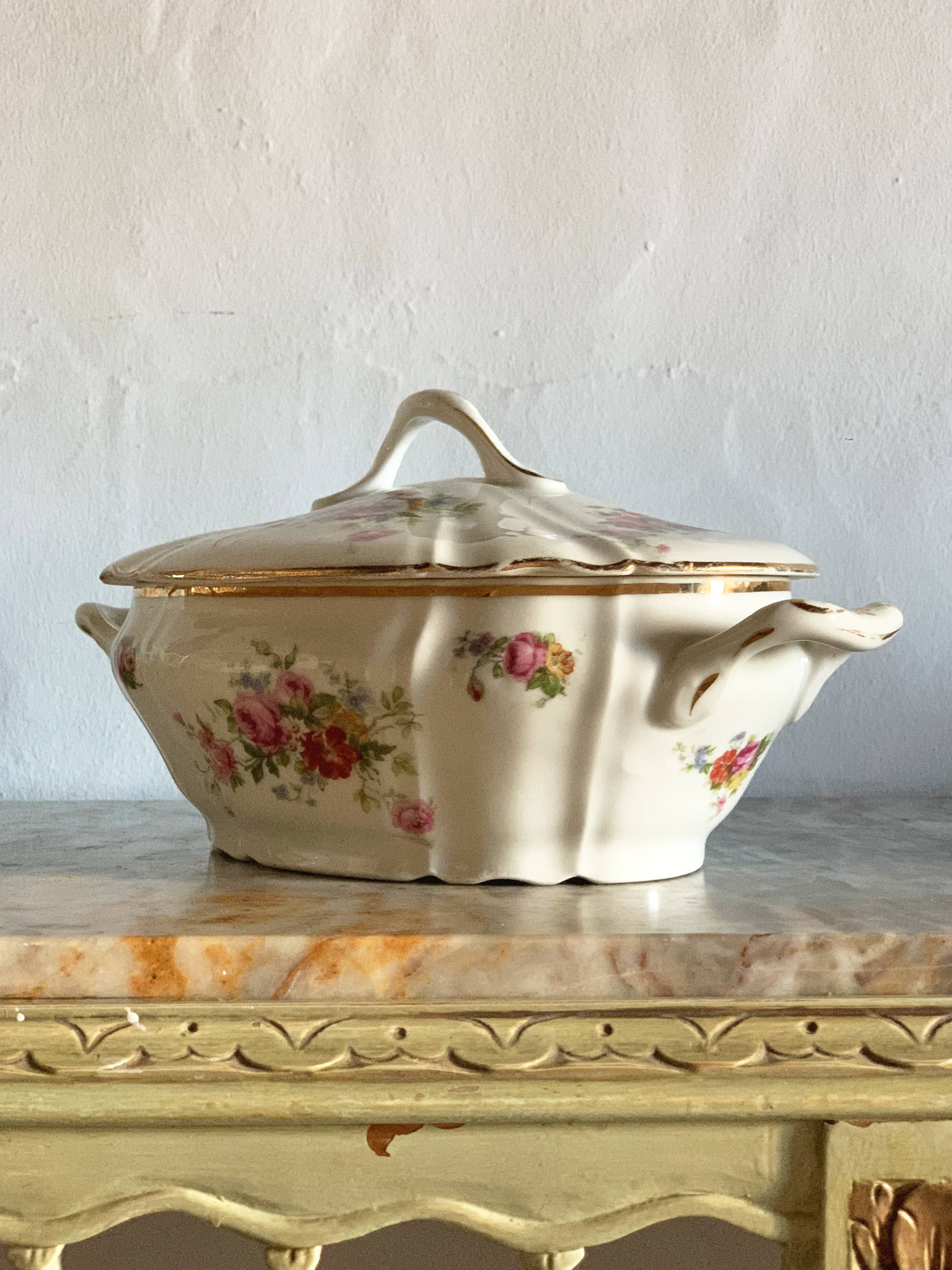 Antique porcelain soup bowl with floral decoration and golden border