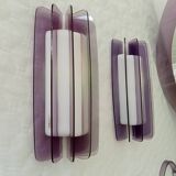 Set of plexiglass wall lights and mirror by Harvey Guzzini, 1970s