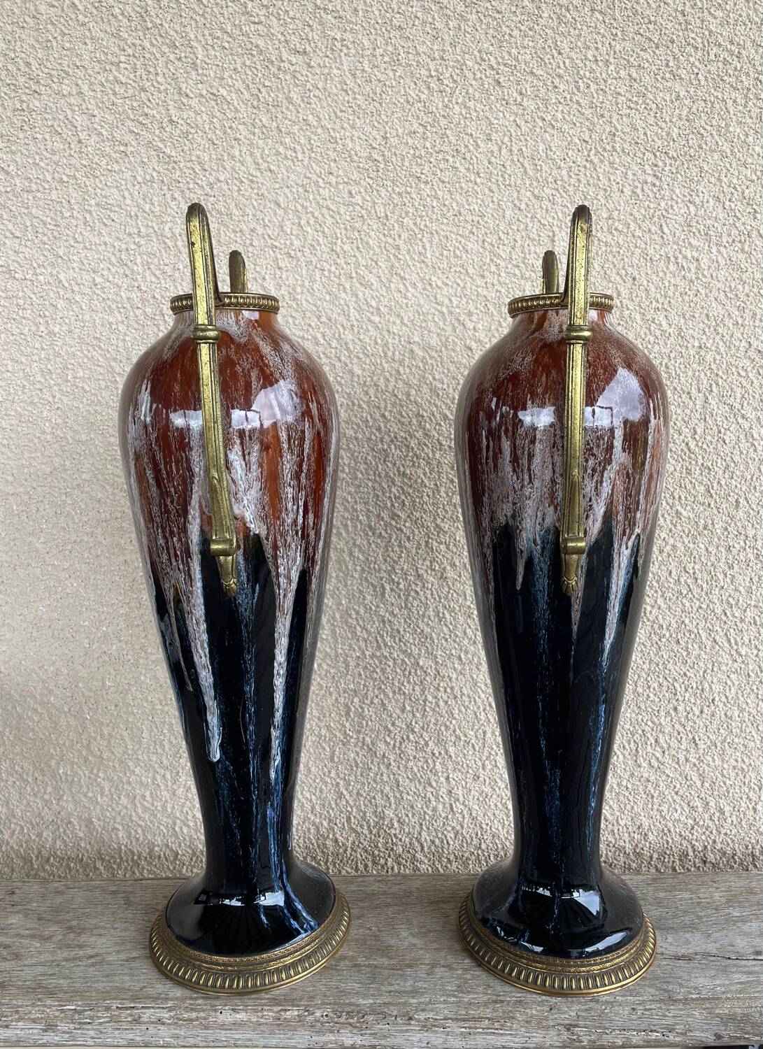 Two large stoneware vases with bronze fittings.