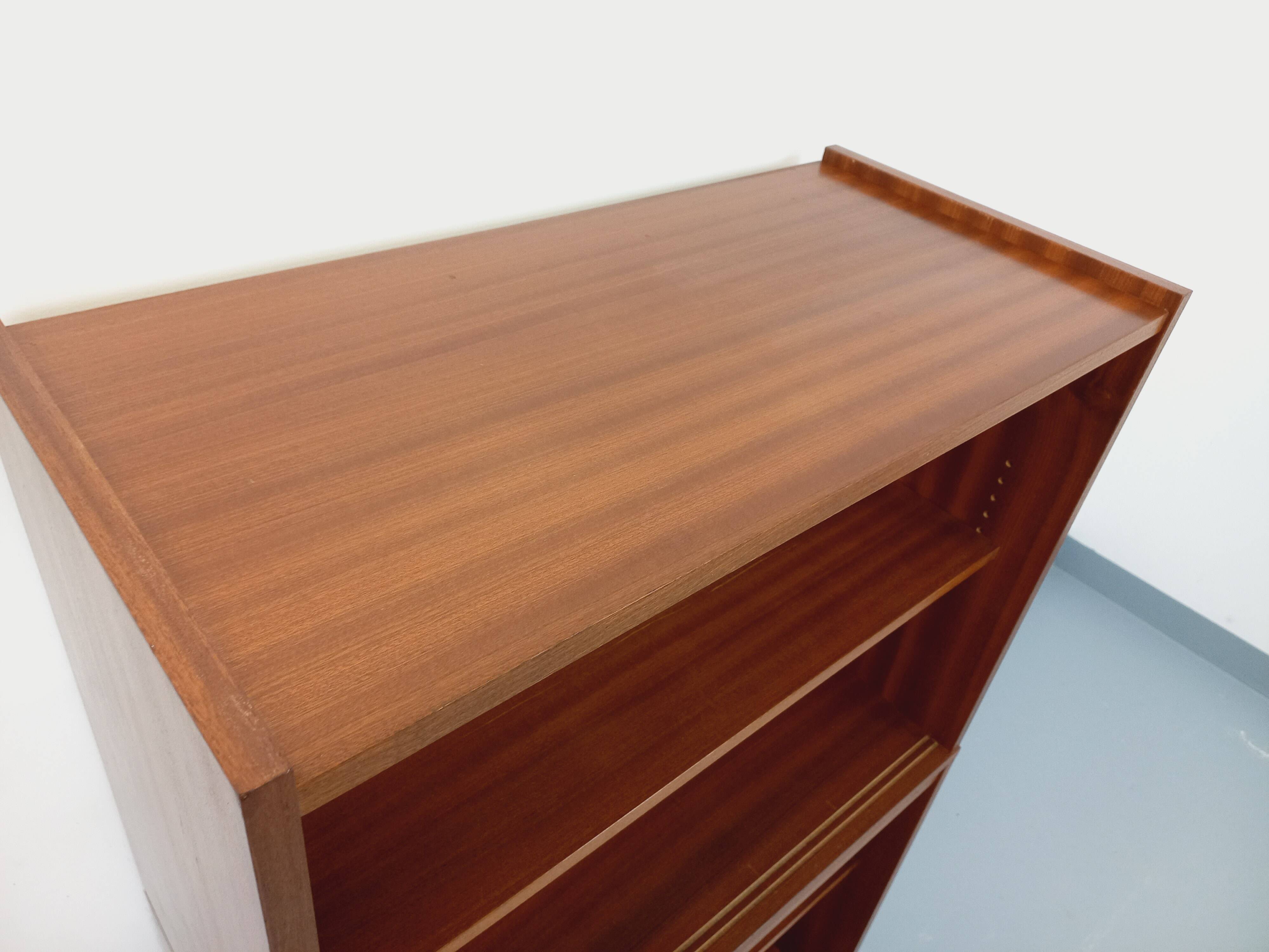 Vintage wooden bookshelf in teak style from the 1960s.