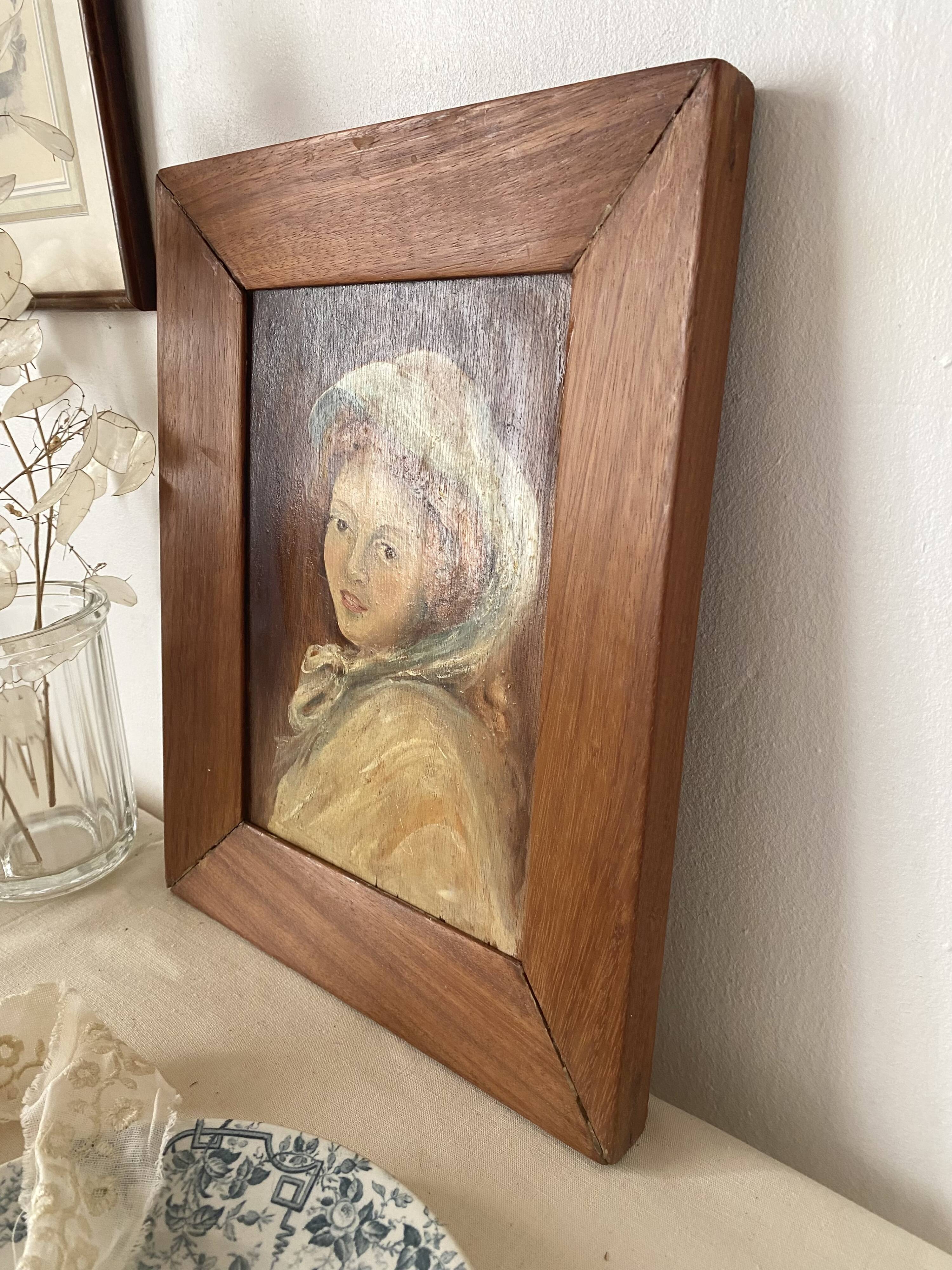 Old oil portrait on wood of a young woman