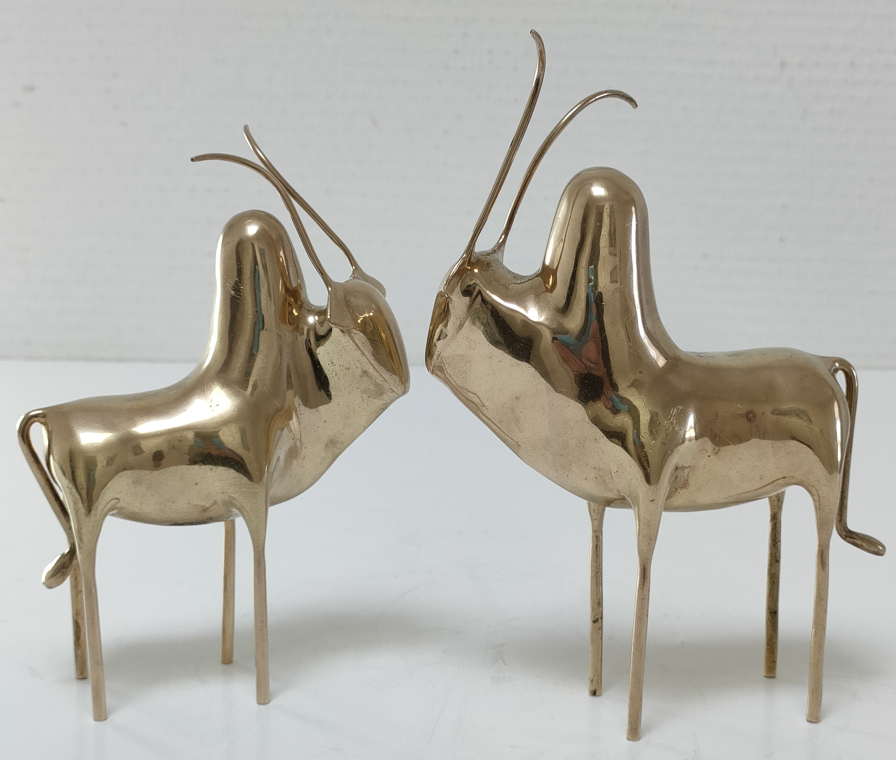 Two stylized zebu with long vintage brass horns