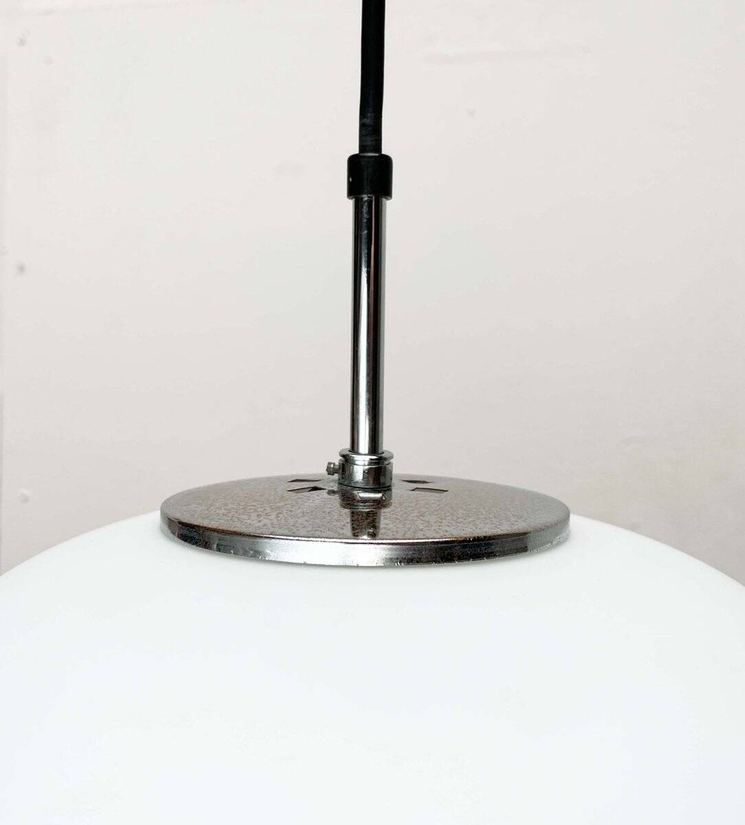 Minimalist suspended glass ball lamp from the vintage German space age by Glashütte Limburg, 1970s.