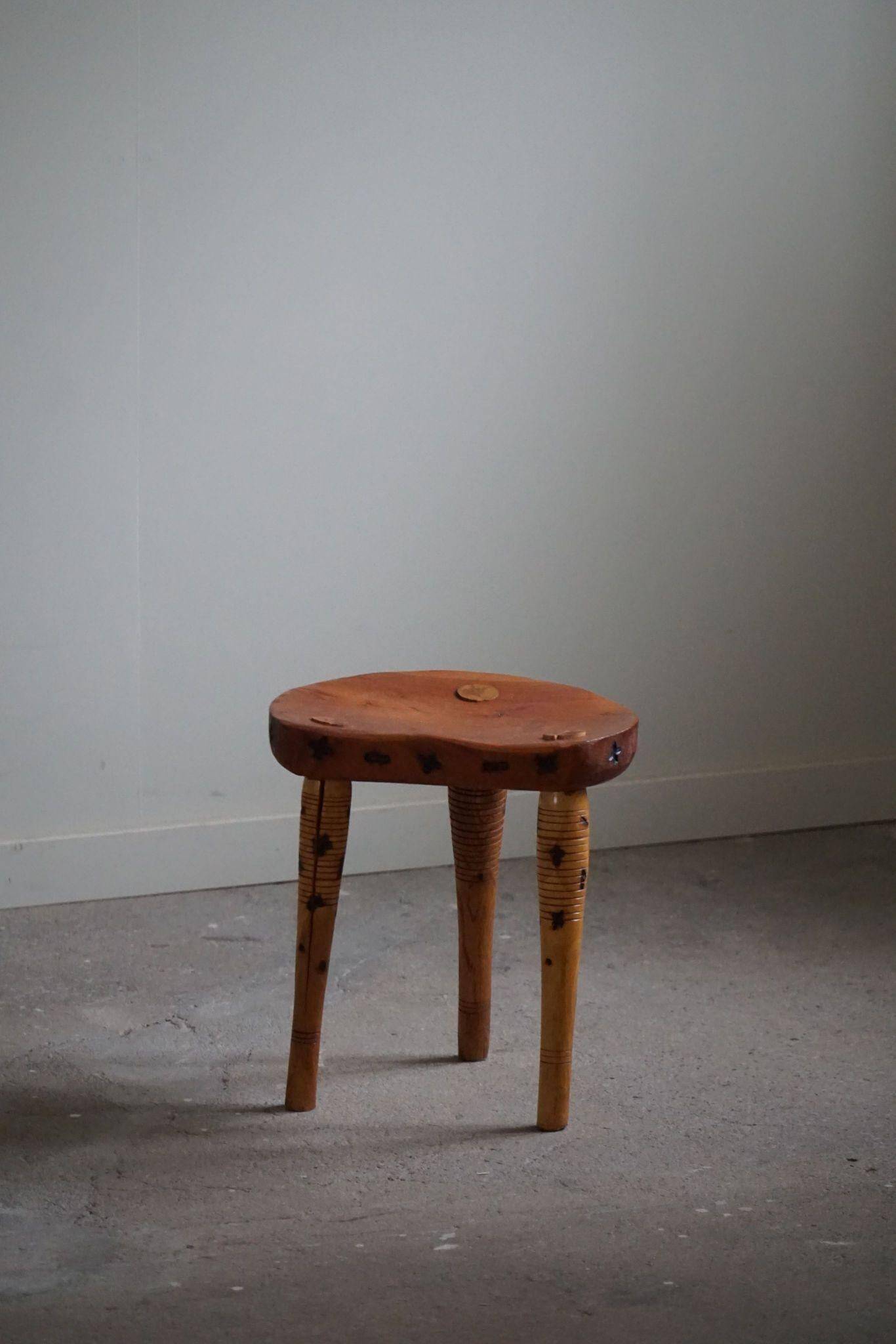 Primitive tripod stool in solid pine, modern Swedish style, from the 1950s.