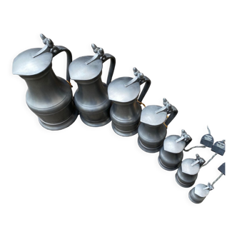 Series of 7 pewter pitchers