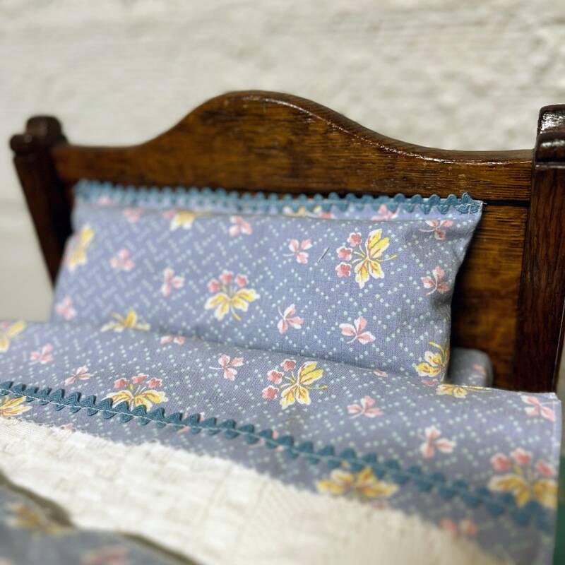 Old doll's bed in varnished wood