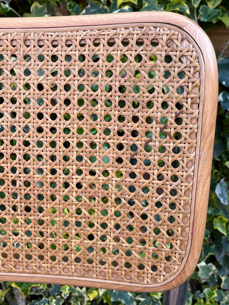 Wooden chair with caning in the style of Marcel Breuer.