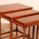 Nested tables in satin wood with brass inlays.