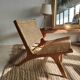 Reclining armchair in natural wood and woven rattan