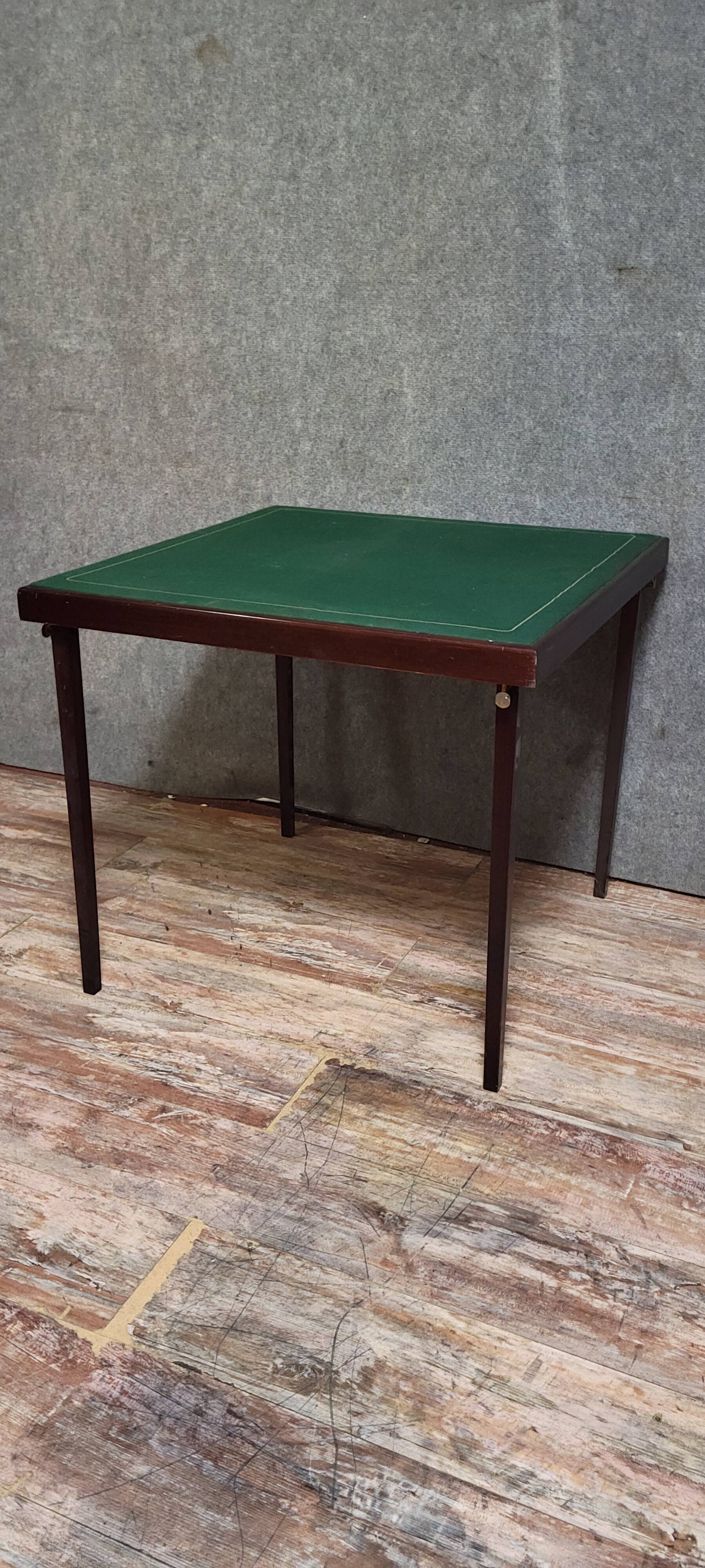 a wooden Bridge game table resting on four thin, straight legs