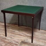 a wooden Bridge game table resting on four thin, straight legs