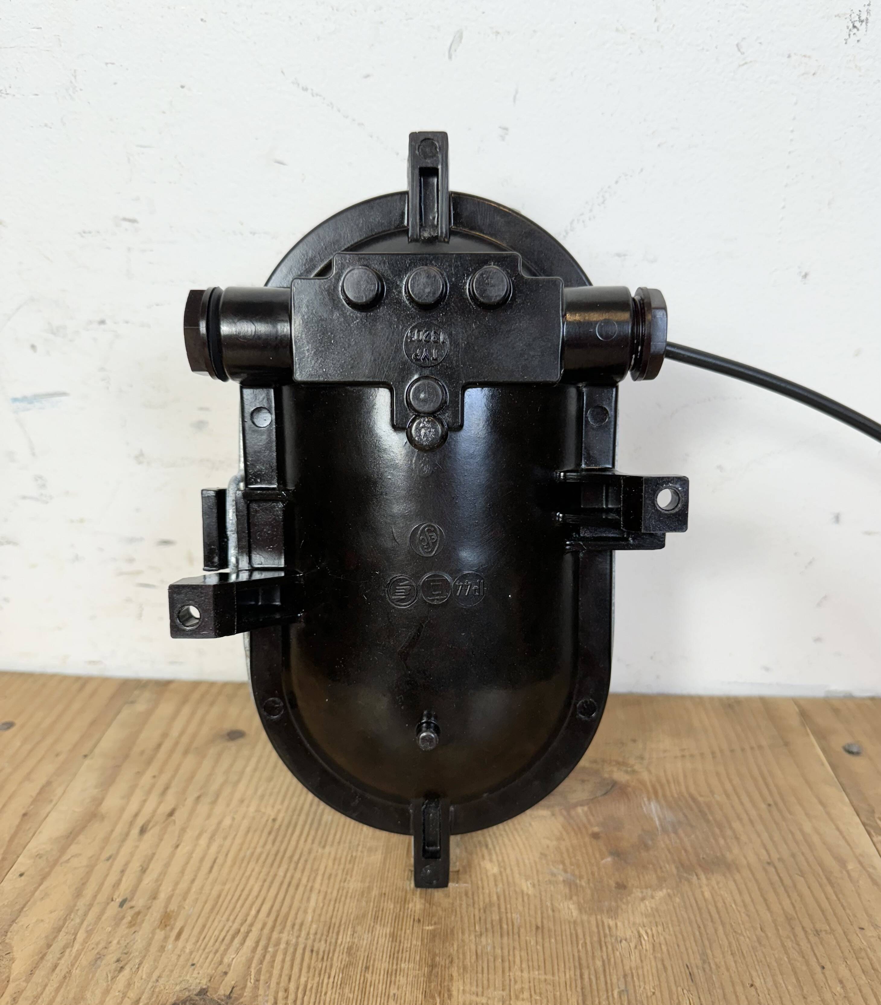 Industrial brown bakelite wall light with frosted glass, 1960s