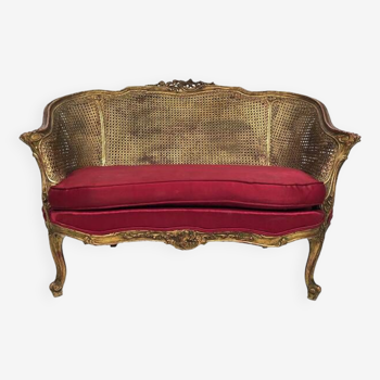Small Louis XV style basket sofa, gilded wood and double canework