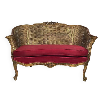 Small Louis XV style basket sofa, gilded wood and double canework