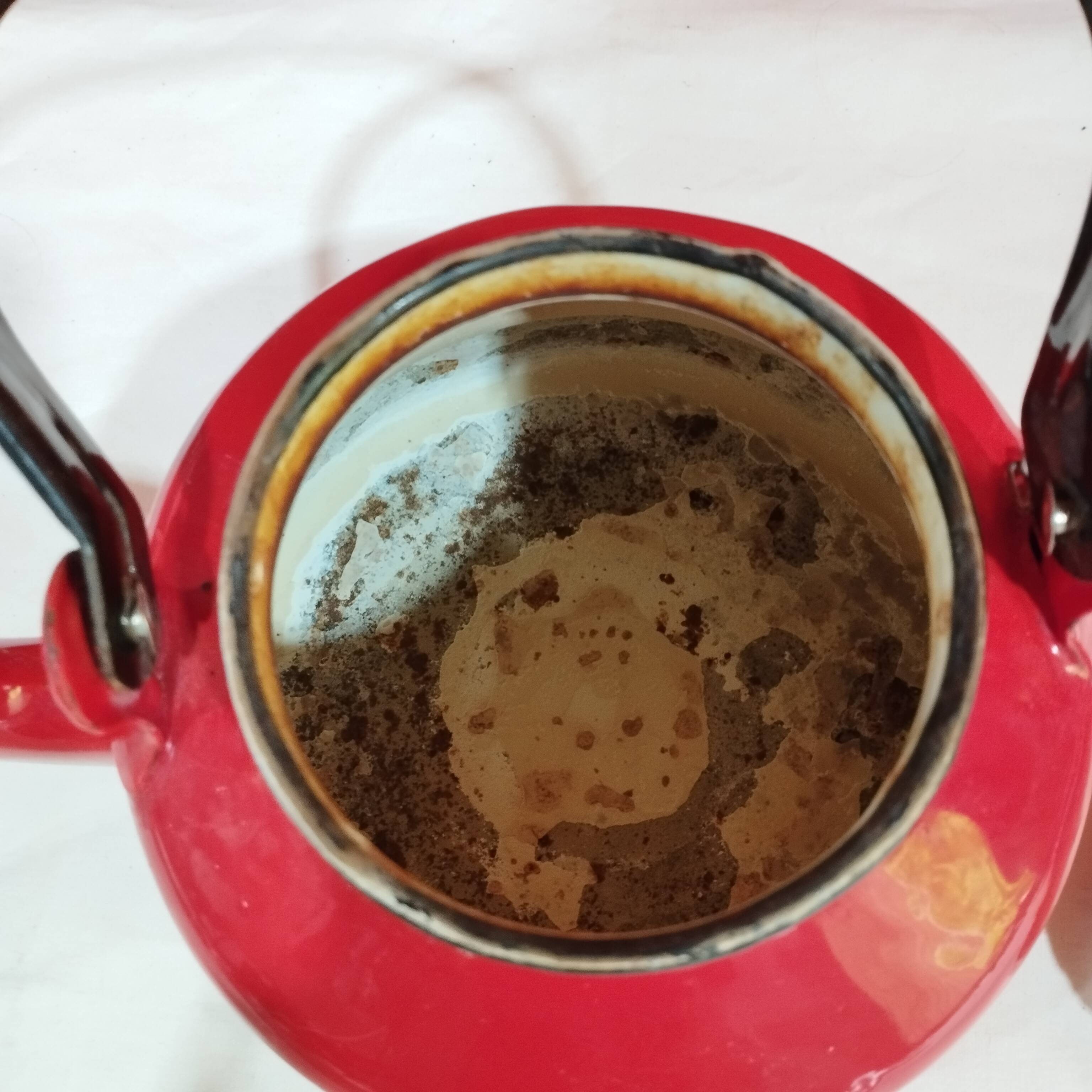 red enamelled sheet metal kettle