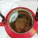 red enamelled sheet metal kettle