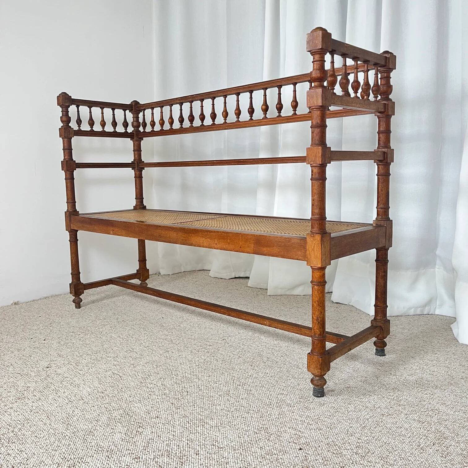 Antique banquette in Louis XIII style, turned wood with caning, late 19th to early 20th century.