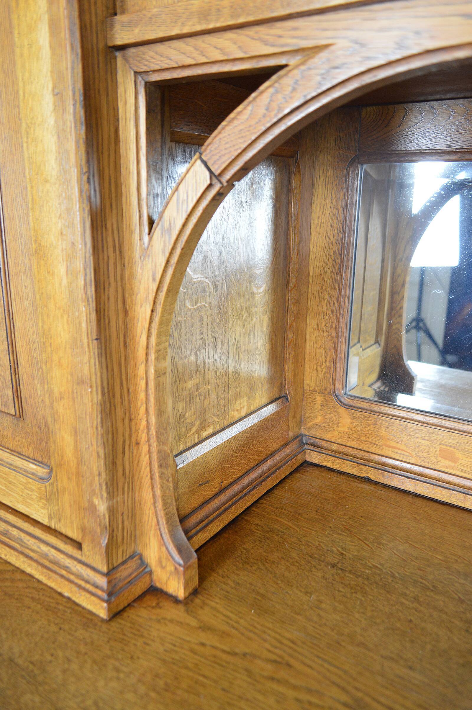 Art Nouveau oak buffet and dinanderie panels, circa 1910