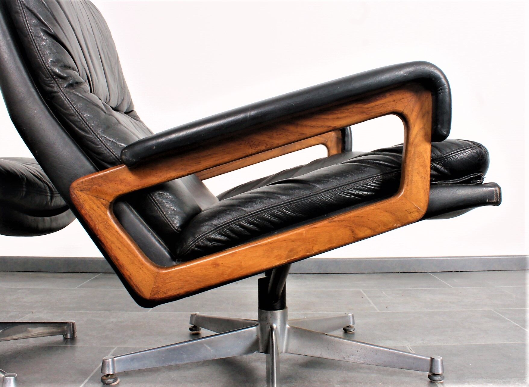 Armchair and footstool by André Vandenbeuck for Strässle in black leather