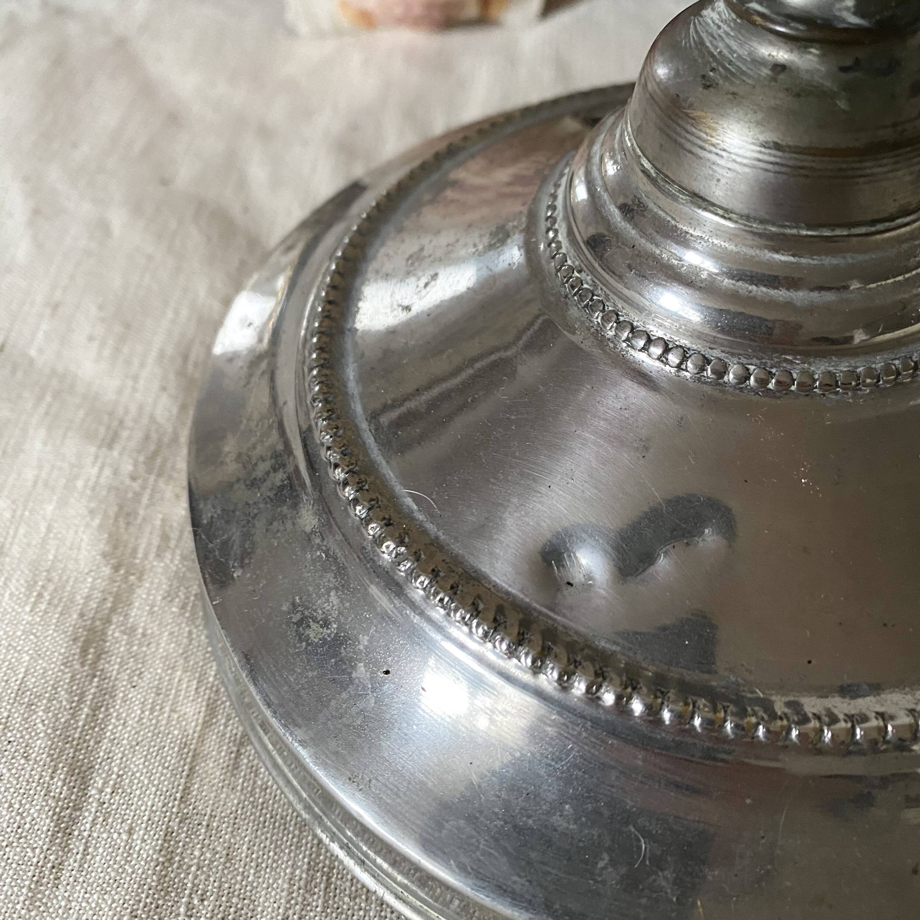 Antique jeweller's lamp, silver-plated base, frosted pink glass shade.