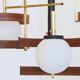 Italian 3-globe pendant light in opaline with teak and brass.