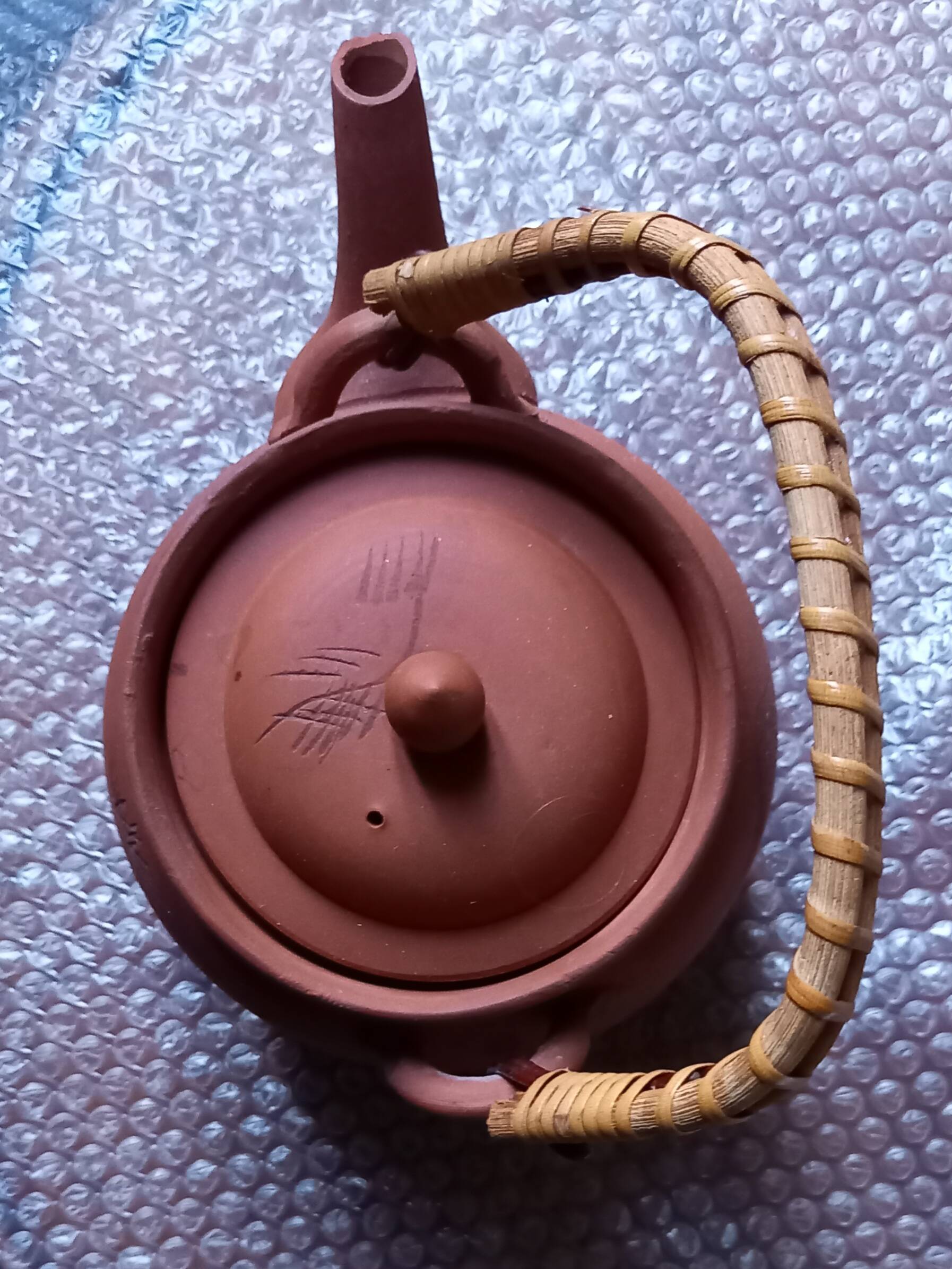 Terracotta and rattan teapot